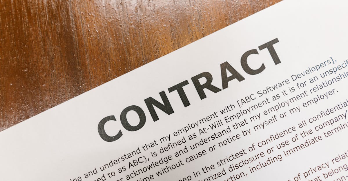 A detailed close-up of a printed contract document on a wooden table surface.